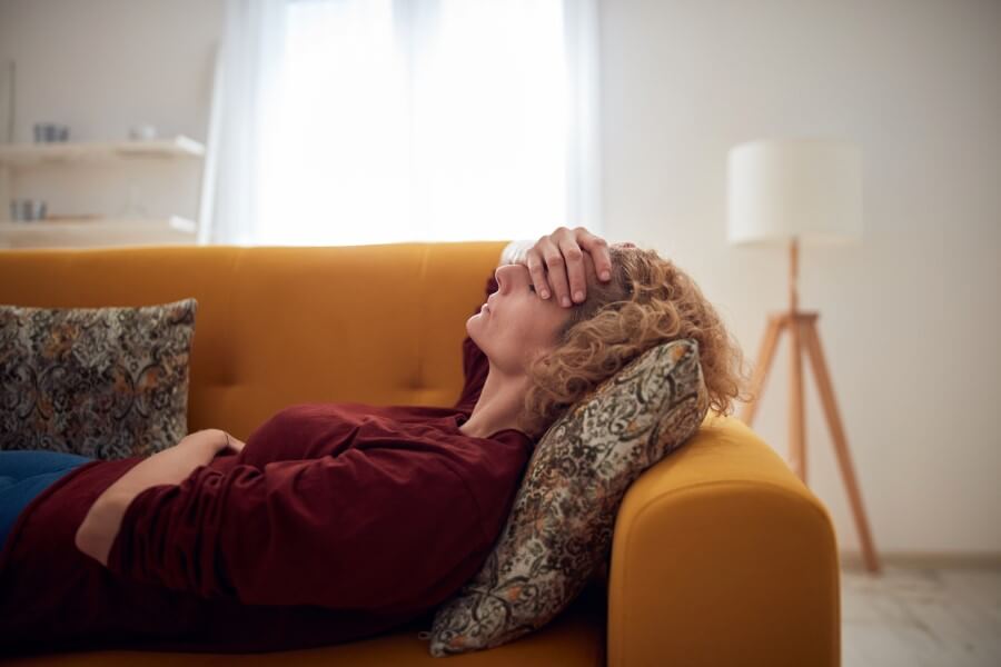 Woman On Couch With Bad Headache